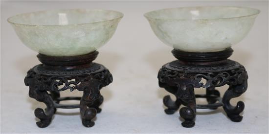 A pair of Chinese ice white and pale green jadeite bowls, early 20th century, diameter 7cm